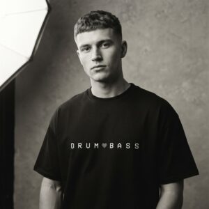 Drum & Bass T-Shirt by SUPERWAPA, black oversized tee worn by a model