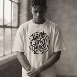 Hustle and Grind T-Shirt by SUPERWAPA, white oversized tee worn by a model