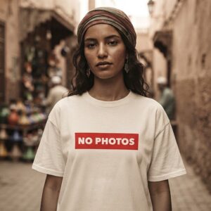 NO PHOTOS T-Shirt by SUPERWAPA, white oversized tee worn by a model