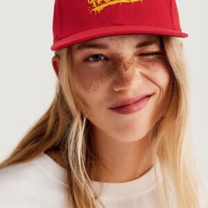 NOT SO FAMOUS Red Cap by SUPERWAPA, red snapback worn by a model